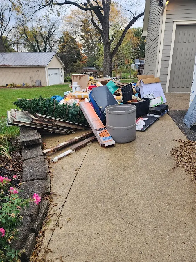 Dumpster being loaded with debris for Commercial Dumpster Rental in Great Neck Estates